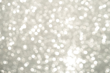 Silver Sparkling Lights Festive background with texture. Abstract Christmas twinkled bright bokeh defocused and Falling stars. Winter Card or invitation	