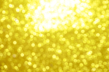 gold Sparkling Lights Festive background with texture. Abstract Christmas twinkled bright bokeh defocused and Falling stars. Winter Card or invitation	