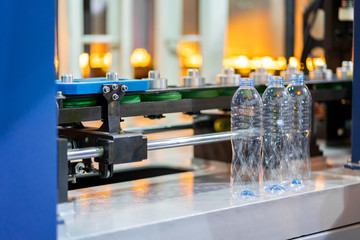 Manufacturing of bottles plastic line, bottle plastic hot blow process transportation raw material by automatic conveyor in the factory