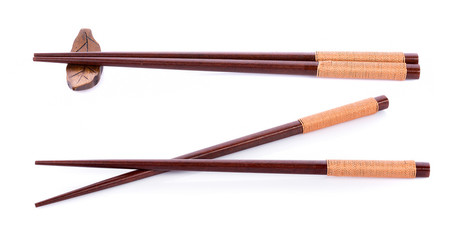 Wooden pairs of chopsticks on white background