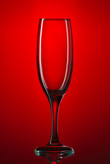 Glass goblet shot on a red background close-up