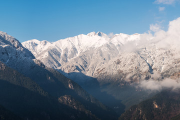 Obraz premium Peaks of Olympus mountain in winter covered in snow and clouds