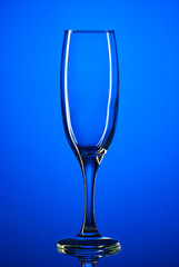 Glass goblet shot on a blue background close-up