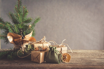 Christmas and zero waste, eco friendly packaging. Woman is wrapping gifts in craft paper on a...