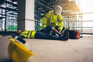 First aid support accident in site work, Builder accident fall scaffolding to the floor, Safety team help employee accident.