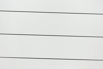 White Iron surface with black planks.