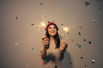 Asian woman fun holding sparklers. Young girl celebrating Christmas or New Year eve party at night. Happy new year