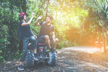 couple driving off road adventure with ATV,UTV bike quad bike on the mountain. couple love high five hand. © Yellow Boat