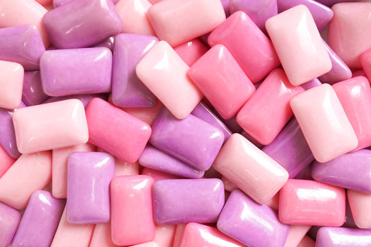 gum. colorful confectionary background of candy gums in different shades of pink and purple.