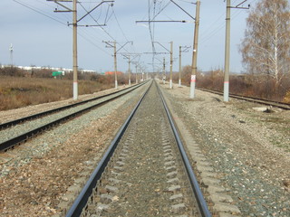 Fototapeta na wymiar Railway. Bright sunny day. The rails go into the distance.