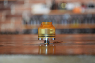 Electronic cigarette on a background of vape shop. E-cigarette for vaping.