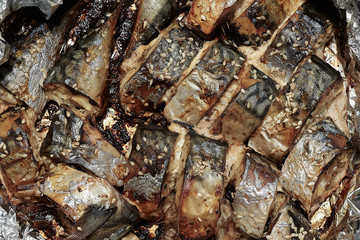 Baked slices of fish mackerel sprinkled with sesame seeds.