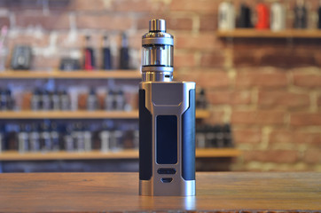 Electronic cigarette on a background of vape shop. E-cigarette for vaping.