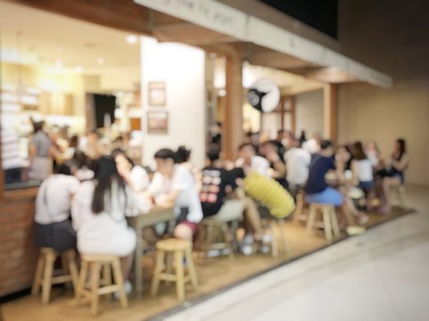 blurred image of People in coffee shop or cafe restaurant with abstract bokeh light image background.For montage product display or vintage tone and light effect