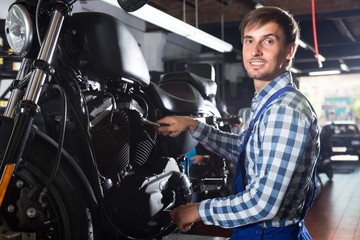 young male mechanic working in auto repair shop