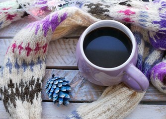 Cup of coffee, Christmas decor, spruce branch, woolen plaid on the window background, home comfort concept, seasonal winter celebrations