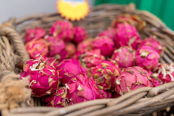 fruits of Hylocereus undatus, dragon fruit or pitahaya in basket at market