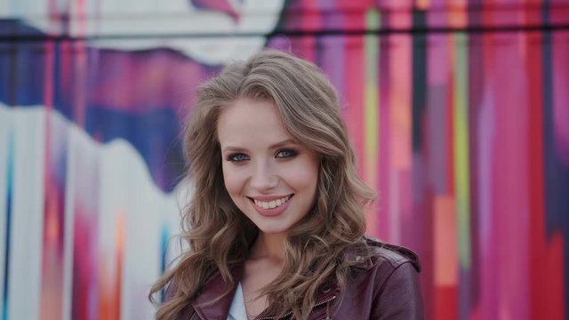 Portrait of a cute girl with a charming prepossessing smile. young woman looking at camera and smiling.