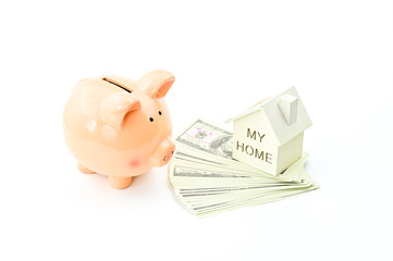 Piggy bank, dollars banknotes and home model on white background, property ladder, mortgage and real estate investment concept