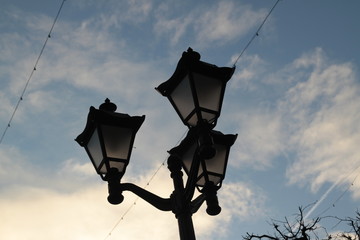 old street lamp on the background of blue sky