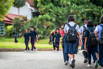 The Asian high school students in white uniform  are coming to school.