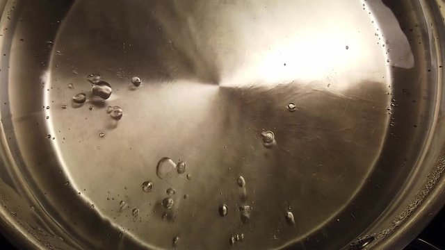 View from above, water starts to boil in kettle.