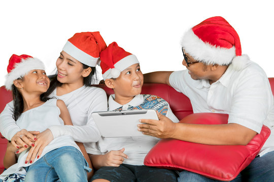 Asian family using a tablet at Christmas time