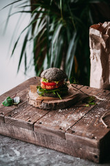 Vegetarian burger with chickpeas on a fresh homemade black bun