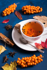 tea with sea buckthorn on a dark background