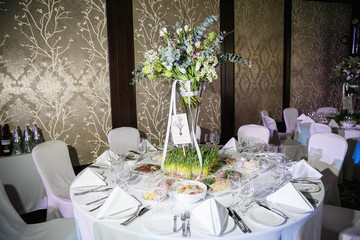 catering at a top event, glasses and flowers on the table, preparation for a significant event, beautiful dishes and glasses on the table, New Year's holiday table	