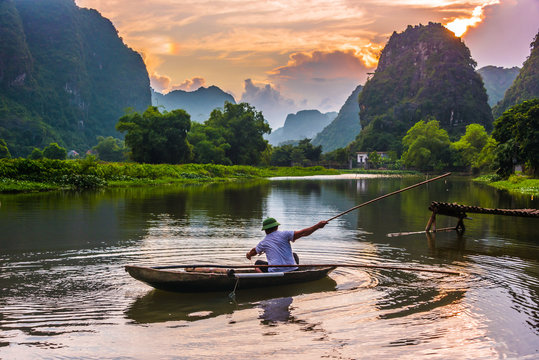 Fisherman on boat in Trang An, near Ninh Binh, Vietnam