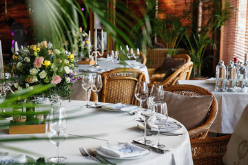 catering at a top event, glasses and flowers on the table, preparation for a significant event, beautiful dishes and glasses on the table, New Year's holiday table