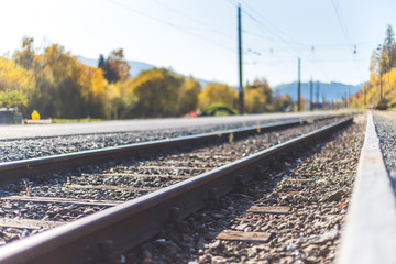 Sustainable traveling by train: Rail track and colorful, idyllic landscape in fall.