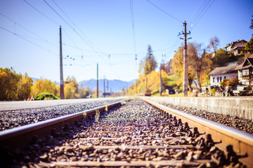 Sustainable traveling by train: Rail track and colorful, idyllic landscape in fall.