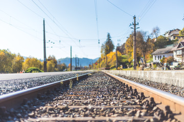 Sustainable traveling by train: Rail track and colorful, idyllic landscape in fall.