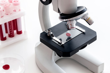 Blood drop under microscope on white background