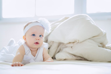 Cute baby girl crawling on the bed
