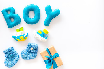 Boy's birthday concept. Set in blue colors with gift box on white backgound top view frame space for text