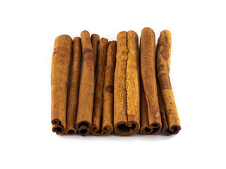 Neatly folded cinnamon sticks on a white background