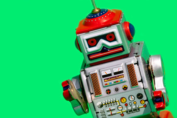 Fototapeta premium Antique tin toy robot on green background. Vintage and classic concept free copy space for text.