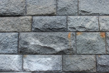Fototapeta premium A wall made of granite rough stones. Moscow. Russia.