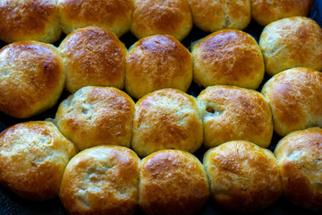Baked hot buns. Sweet buns on a baking sheet.
