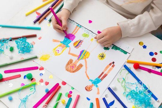 Child draws his friends with markers. Creative activities in kindergarten. Children's friendship