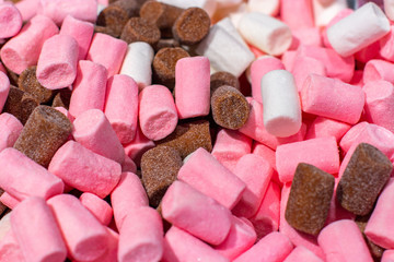 Sugar-coated marshmallows, pink white brown coffee strawberry chocolate closeup. Sweet dessert background wallpaper backdrop