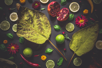 Food collage on black background with flowers and leaves
