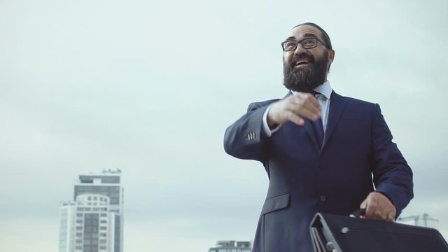 Cheerful businessman making yes-gesture, celebrating lucrative deal, profit