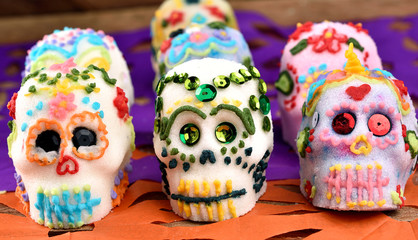 Skulls made by hand, made of sugar decorated with colored glass and sequins. Placed in confetti and...