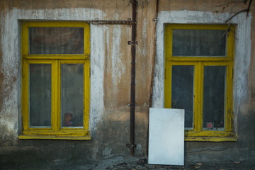 Fototapeta na wymiar Two windows ground floor of an old stone house. Voronezh, Russia.