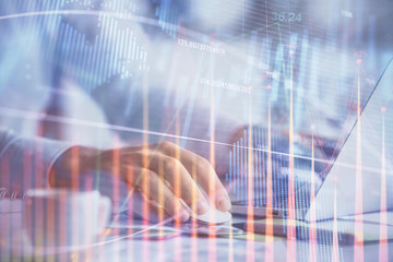 Double exposure of forex graph with man working on computer on background. Concept of market analysis.