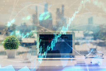 Stock market graph and table with computer background. Double exposure. Concept of financial analysis.